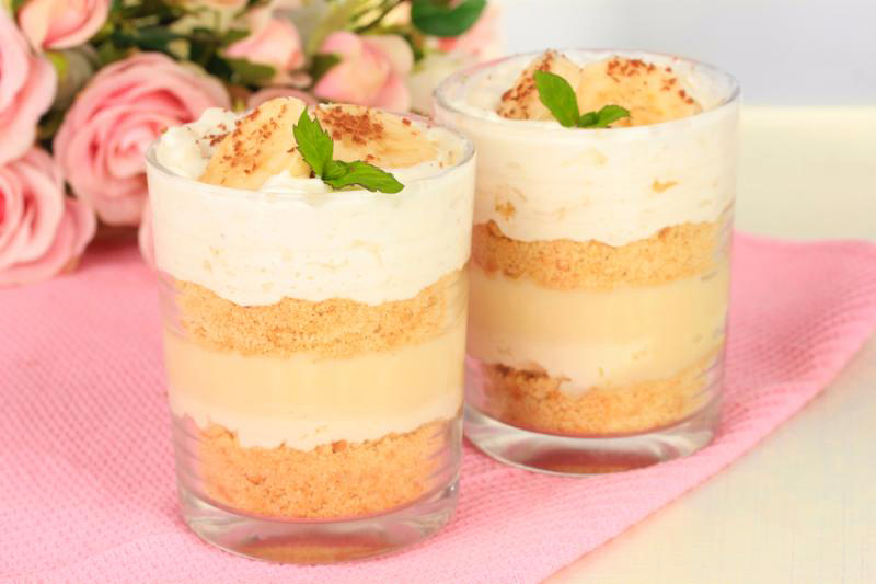Delicious dessert with banana and caramel on table close-up