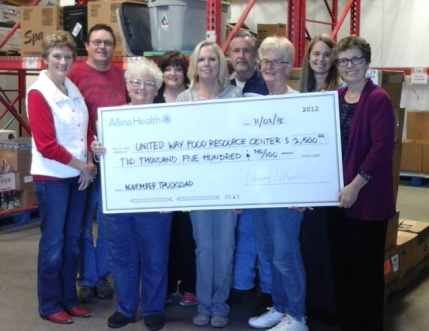 Allina volunteers presenting check to United Way_s Jean Needham