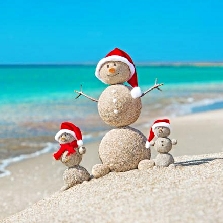Snowmans family at sea beach in santa hats. New years and christmas holiday in hot countries concept.