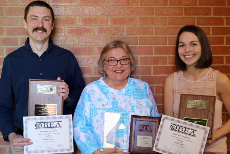 KGOU staffers holding plaques