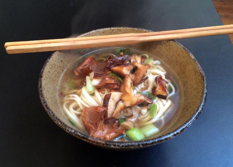 bowl of asian noodle soup with mushrooms