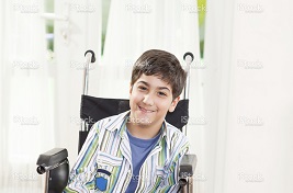 Hispanic young boy in a wheelchair