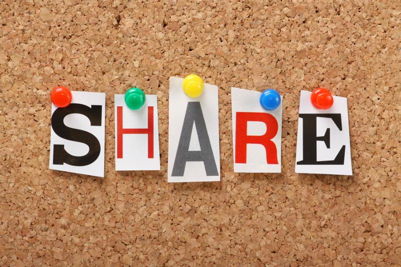 The word Share in cut out magazine letters pinned to a cork notice board, Sharing files, photos and information is an increasing aspect of social networking, online marketing and blogging.
