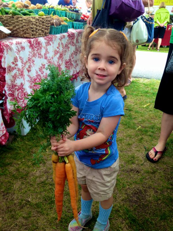 Cute Girl Holding Rainbow Carrots