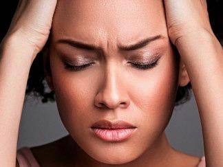 Frustrated frowning woman, eyes closed and hands holding her head