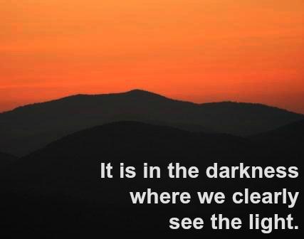 The light of dawn behind dark mountains