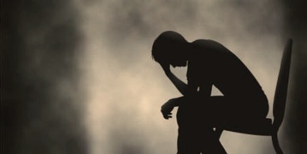 Silhouette of a grieving man