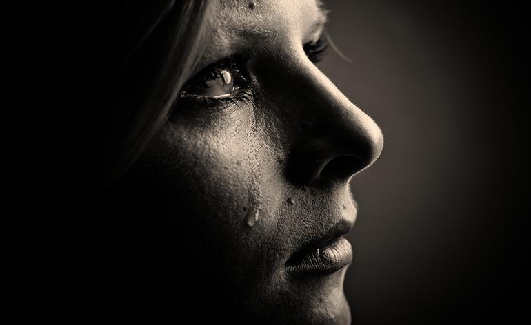 A sad woman looking up