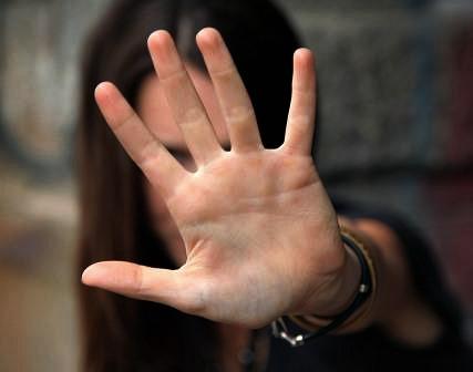 A single hand, outstretched, signaling to stop