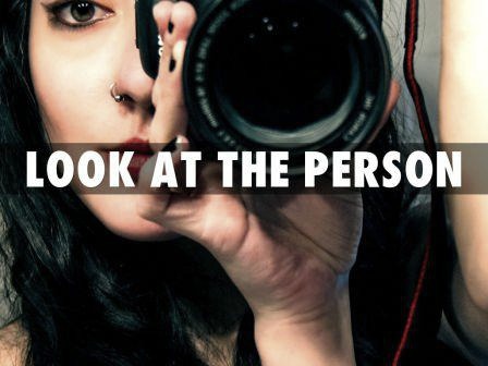 A woman looking through a camera