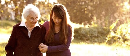 A young woman helping an older one