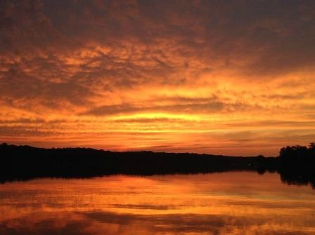 Beautiful sunset reflected in clouds over a lake