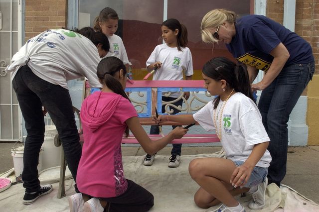 Children helping to restore old furniture