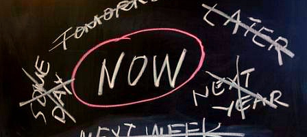 NOW written on a chalk board