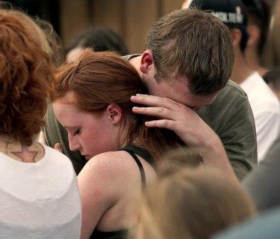 A young woman comforting a grieving man