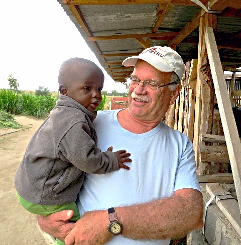 Man holding a child in Kenya