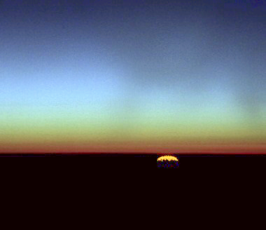 As a new day dawns, the first sign of the sun appears, but before the horizon.