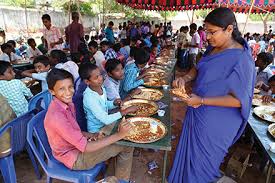 A woman volunteering to feed children