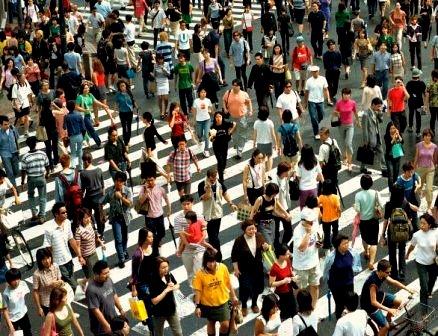 A crowd of people walking in all directions