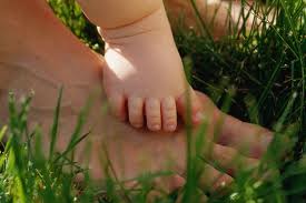 BabyFeetonParentsinGrass