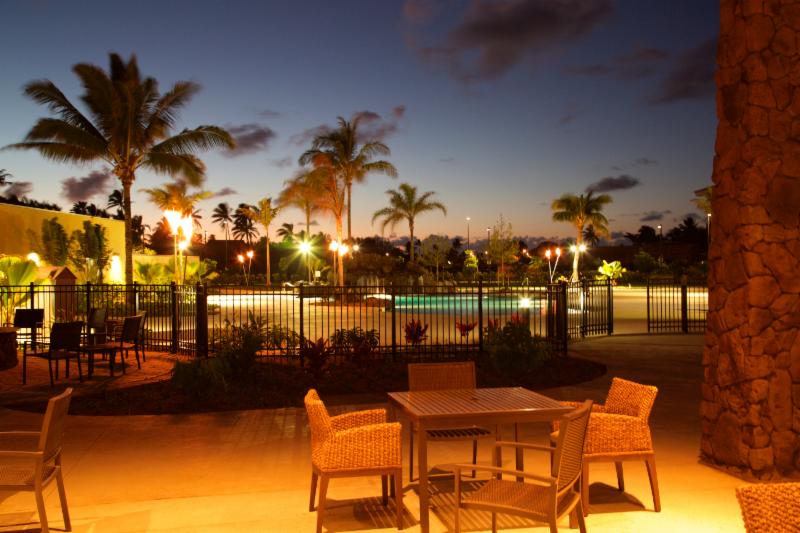 A spacious patio and firepit look out over the swimming area