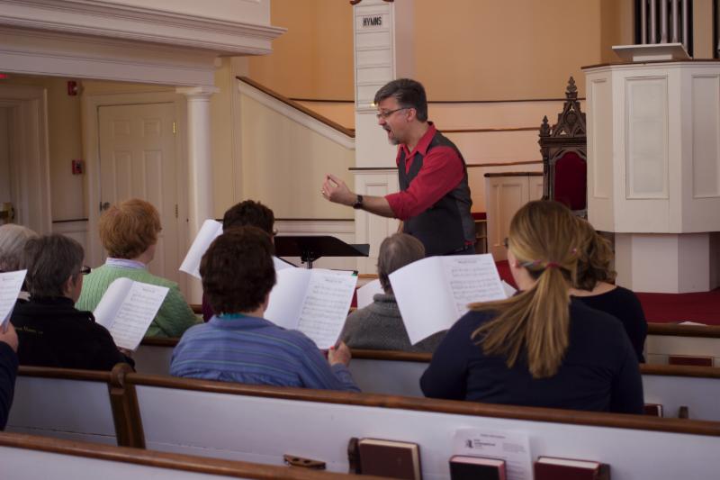 Guest Conductor and Composer Kevin Boesiger working with the choirs in the FCC Sanctuary