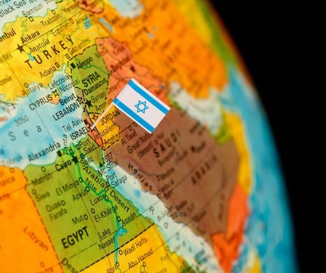 map with miniature flag of Israel .Selective focus on Israeli Flag. Detail Globe Backlit lighting