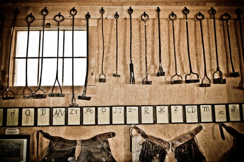 Old west iron brands in a horse shed.