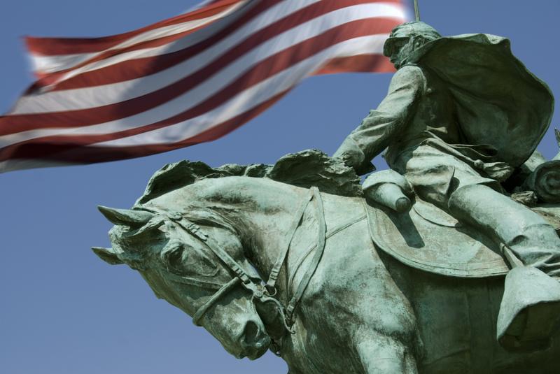 A detail of the Ulysses S. Grant Memorial with Old Glory flying in the background.  The Grant Memorial includes the largest equestrian statue in the United States. 
