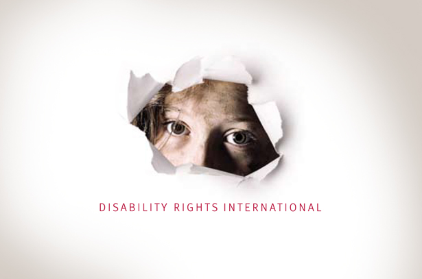 White sheet of paper with a torn hole showing a neglected child_s dirty face Below face it says Disability Rights International