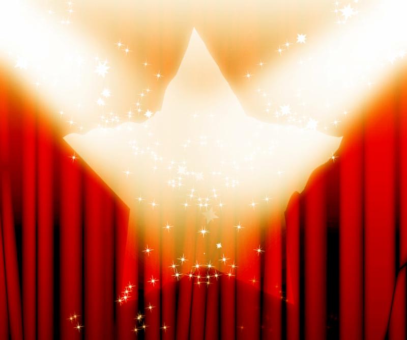 red movie or theater curtains with a bright spotlight on it