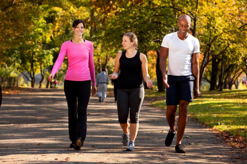 Three people walking in a park getting some exercise