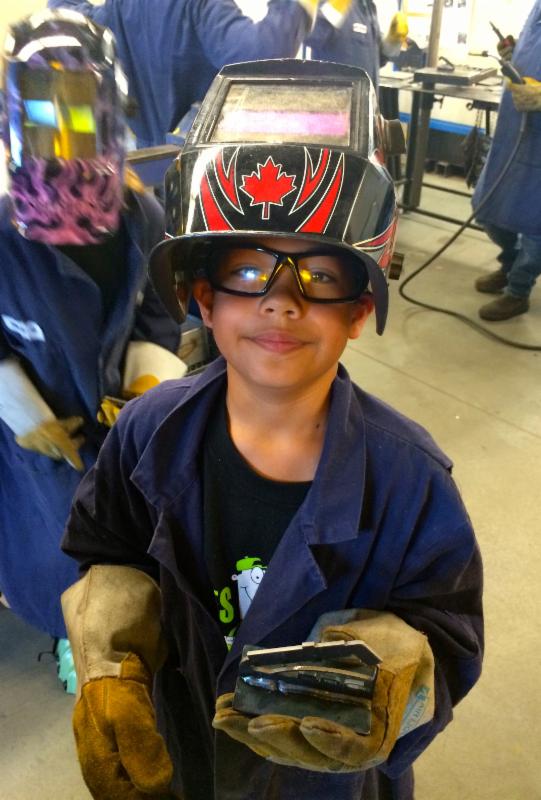 Showing off his weld in Trades Sampler Camp.