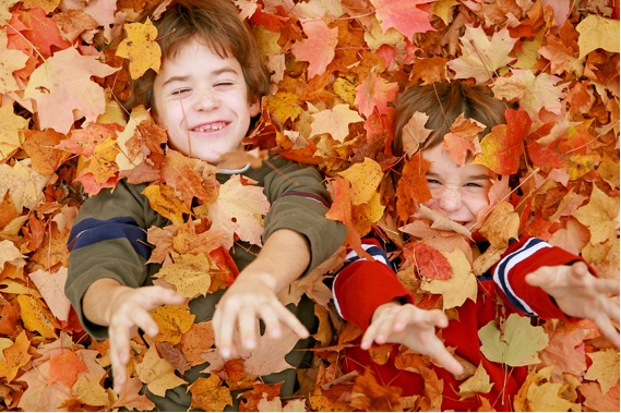 kids in autumn leaves