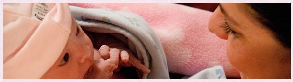 newborn looking at mama
