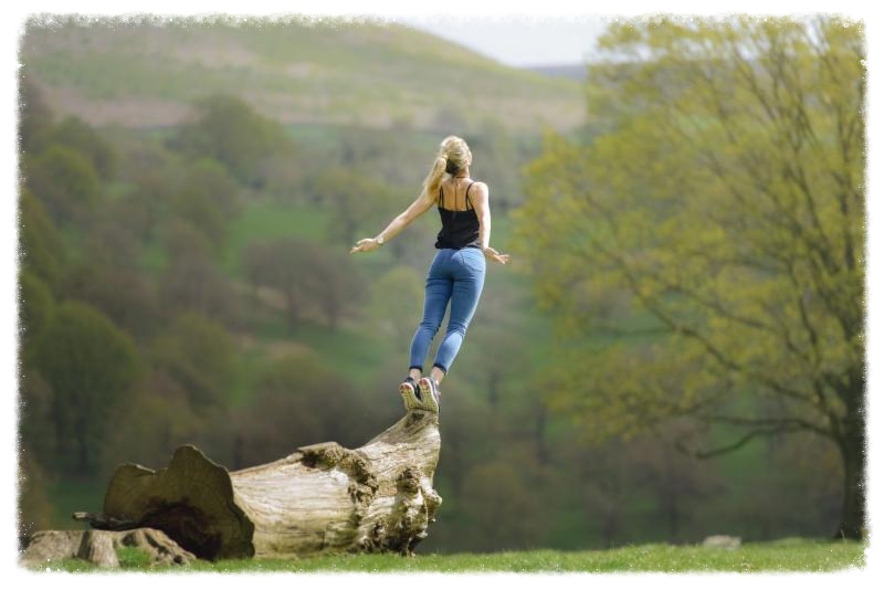 woman balancing on rock