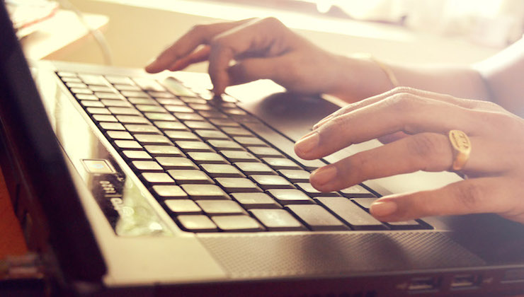 hands typing on a keyboard