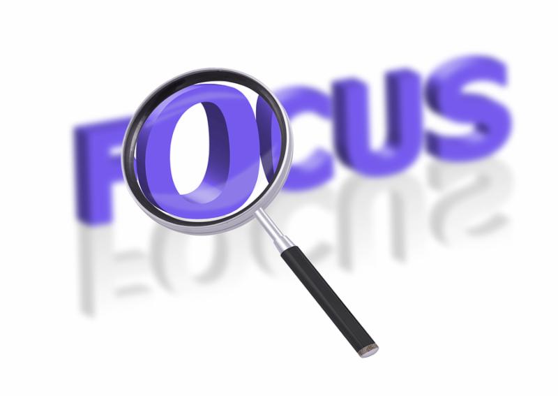 magnifying glass enlarging part of 3D word focus in blue with reflections blurred