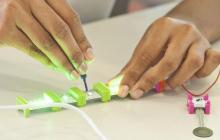 Hands working with light-up electronics 