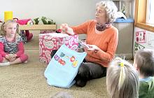 Storytime To Go volunteer with children