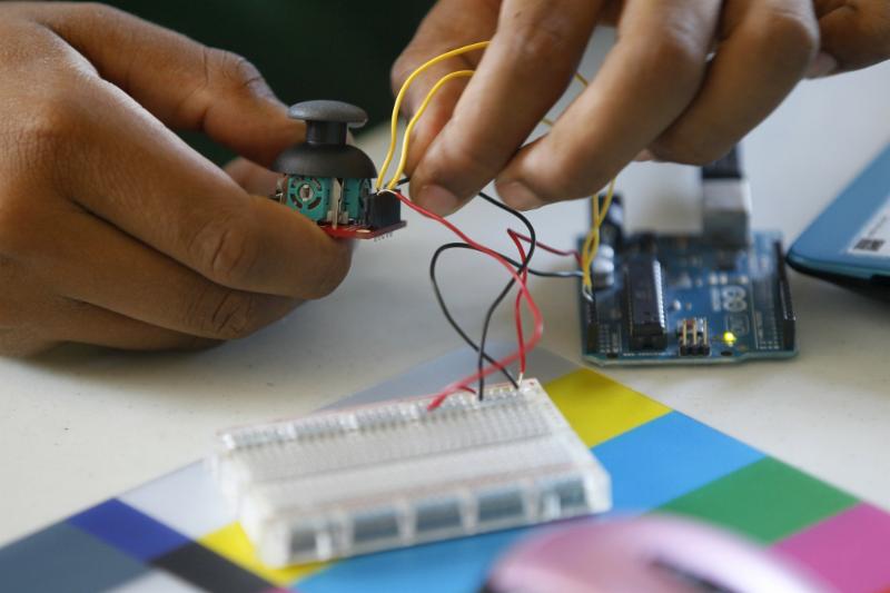 Hands working with electronics