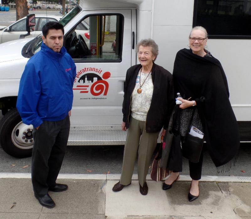 event sponsors in front of paratransit van  