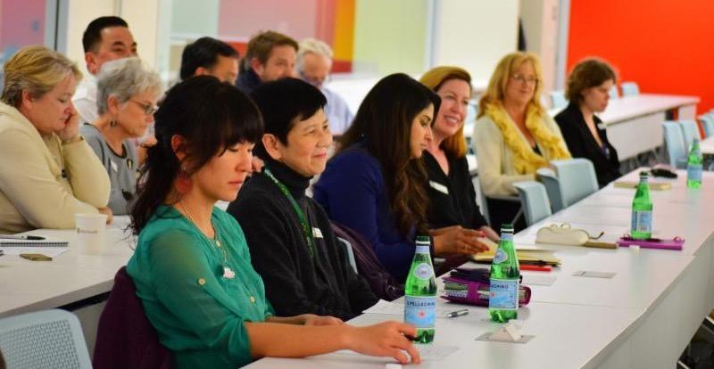 participants at tables smiling