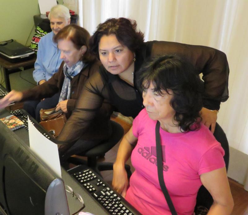 Trainer helping students with computers
