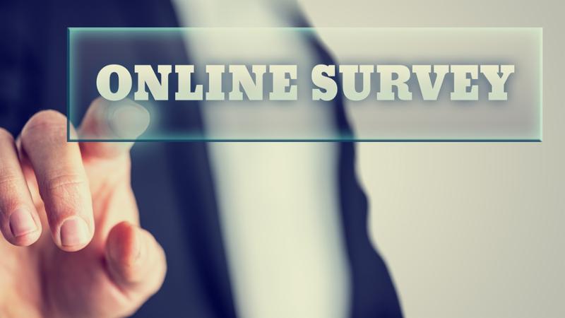 Male hand activating an Online survey button on virtual screen.