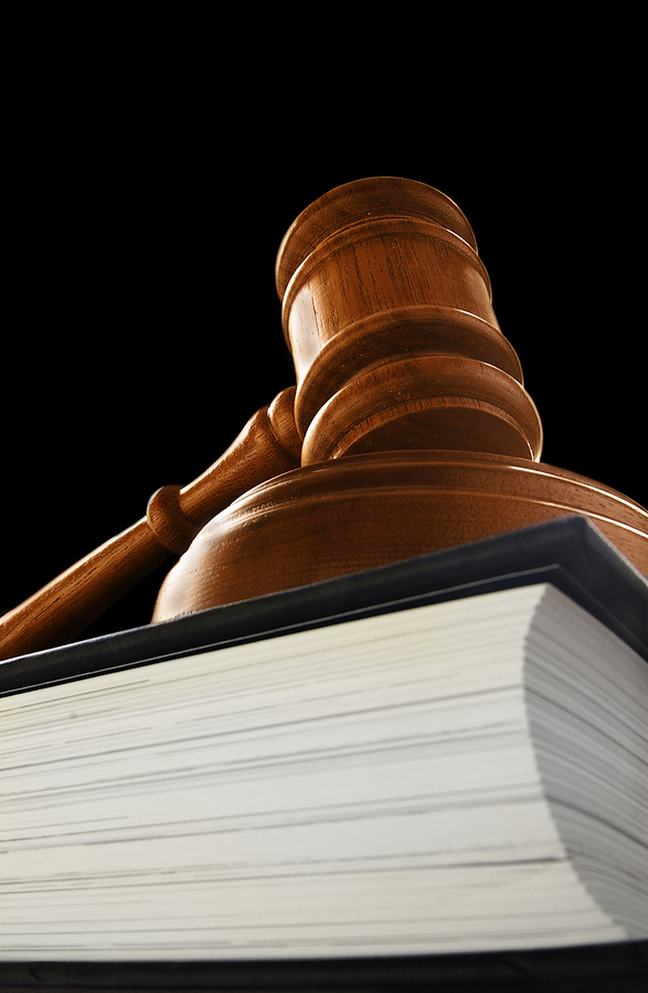 judge s court gavel on a law book on black