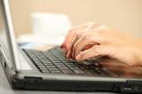Hands on a laptop keyboard