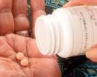 Pills shaken from bottle to hand