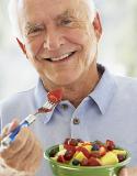 Older man eating fruit
