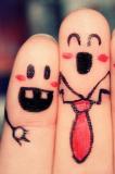 Two fingers with characters drawn on